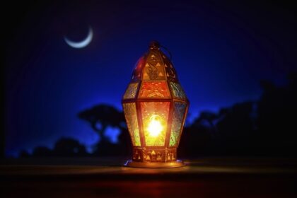 دانلود یک چراغ رنگارنگ روشن رامان در برابر آسمان شب آبی با ماه هلال ماه