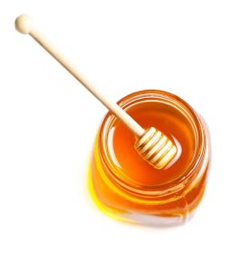دانلود عسل آب پرتقال با عسل در شیشه ای جدا شده بر روی زمینه سفید سفید ماکرو. بستر چوبی عسلی نزدیک