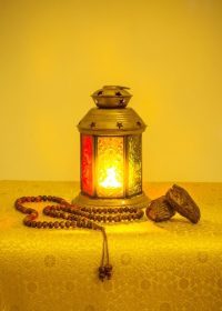 دانلود پیشینه جشن رمضان. چراغ رمضان سنتی با میوه خرما و مهره های نماز اسلامی. طرح رنگ زرد روشن طلایی.