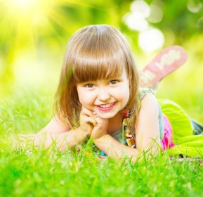 دانلود پرتره یك دختر كوچك لبخند بر روی چمن سبز. کودک سه ساله ناز از طبیعت خارج از منزل لذت می برد. بچه بی سرپرست سالم پ