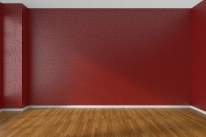 دانلود اتاق خالی با دیوارهای قرمز و کف پارکت چوبی زیر نور آفتاب از طریق پنجره ، تصویر سه بعدی