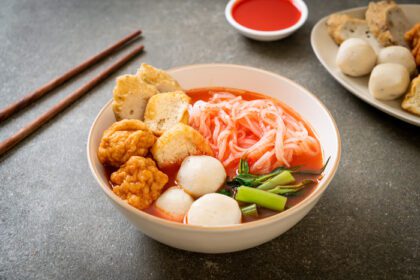 دانلود عکس رشته فرنگی کوچک تخت با توپ ماهی و توپ میگو در سوپ صورتی ین تا چهار یا ین تا فو سبک غذایی آسیایی