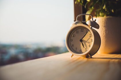 دانلود عکس ساعت زنگ دار چوبی در صبح با نور خورشید