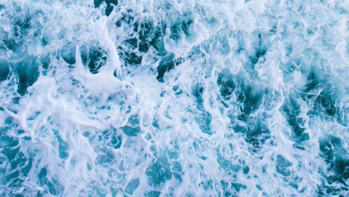 دانلود عکس نمای بالا با امواج و حباب های سطح آب آبی اقیانوس