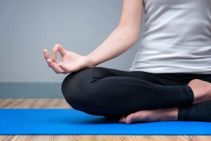 دانلود عکس زن جوان هنگام تمرین یوگا آرامش خود را حفظ کرده و مدیتیشن می کند
