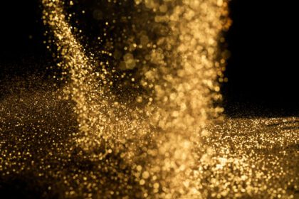 دانلود عکس گرد و غبار ذرات طلا برای پس زمینه